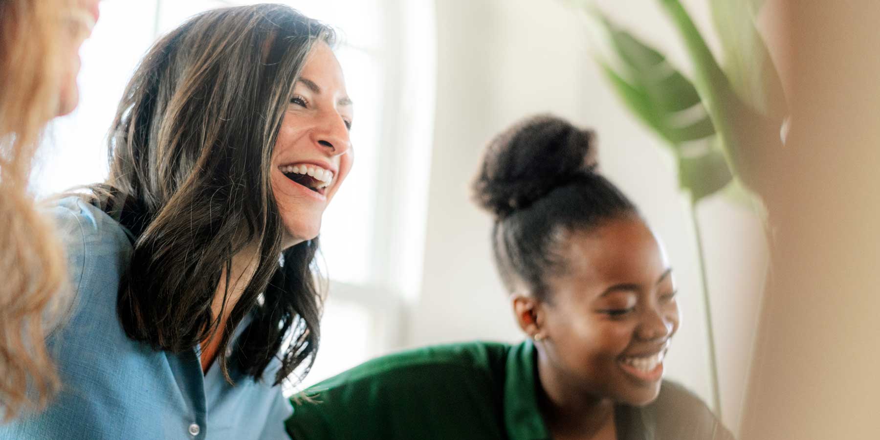 three confident women laughing