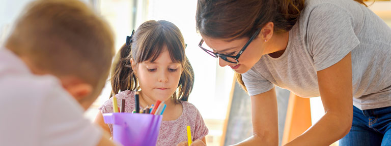 Teacher working with two children, a boy and a girl